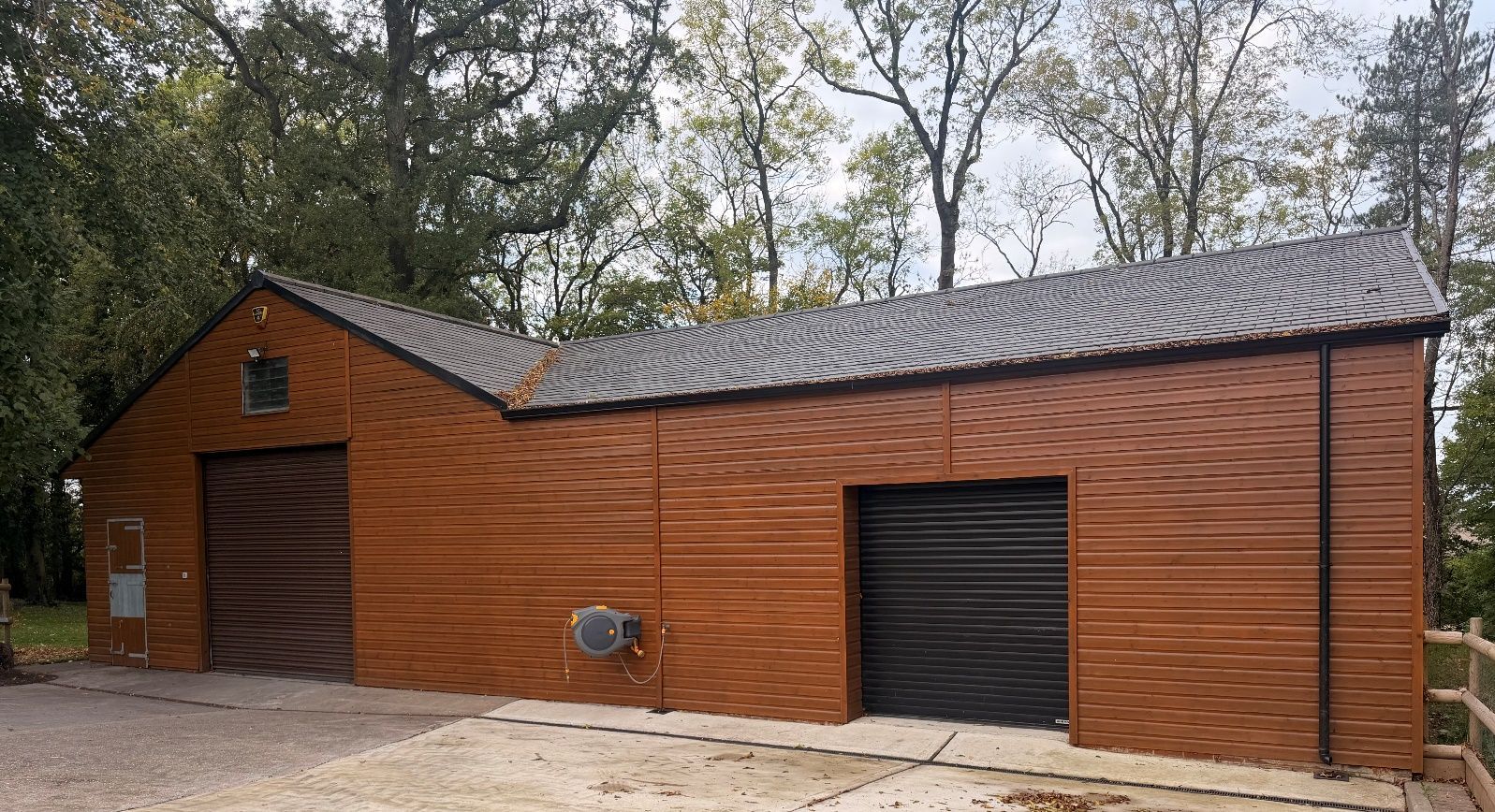 The completed timber-clad estate building with roller doors