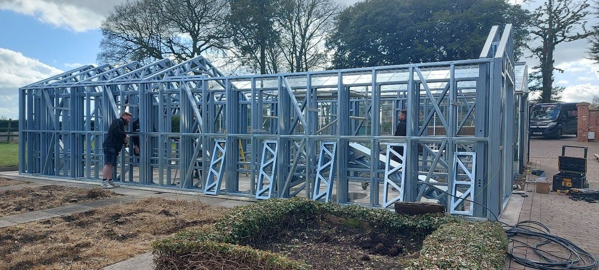 The frame being erected on the base of the former greenhouse